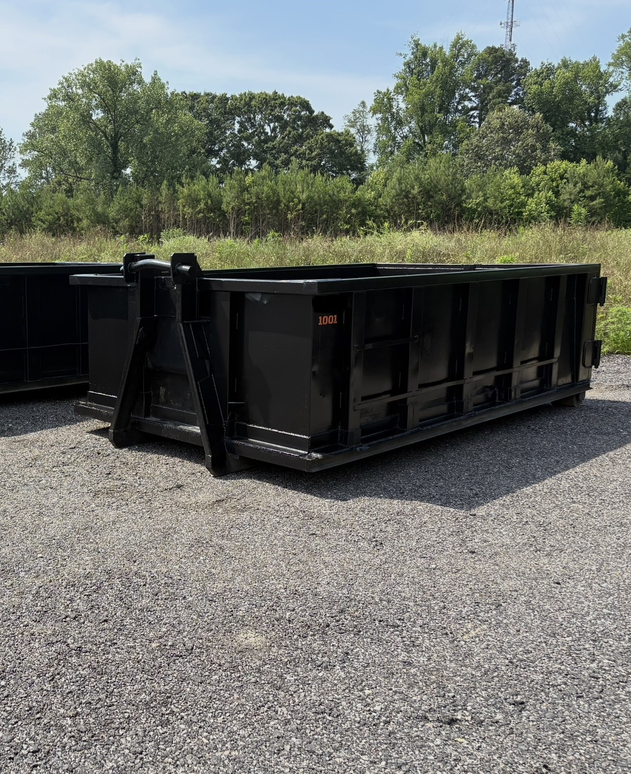RISE Dumpsters 10-yard container dropped safely on a residential driveway with wood board driveway protection.