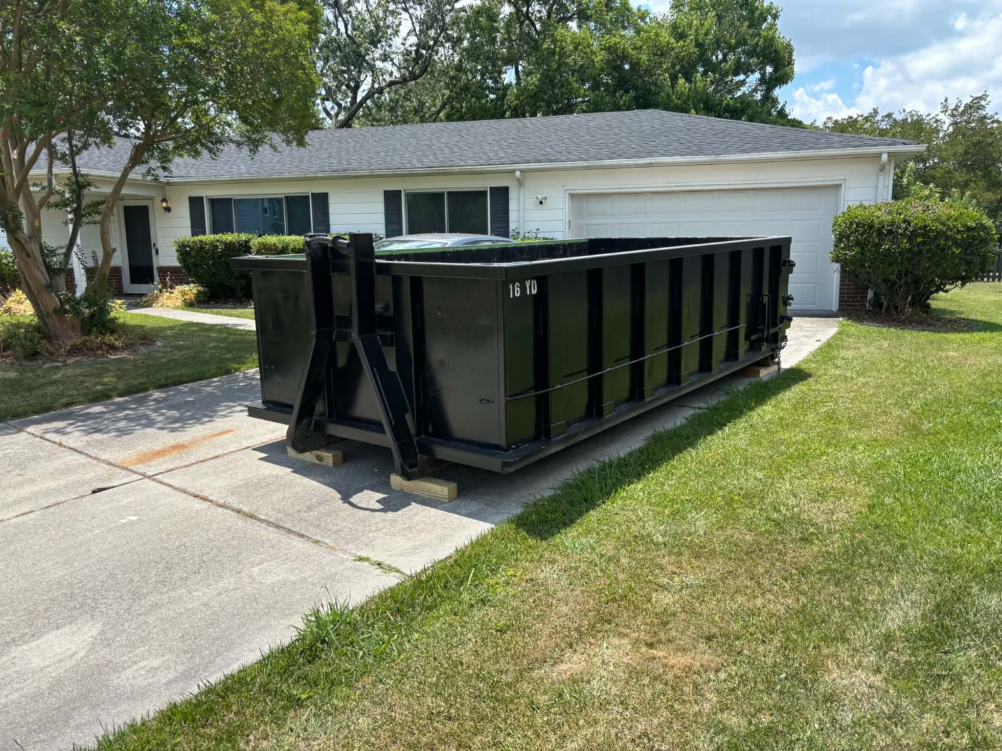 RISE Dumpsters 15-yard roll-off dumpster rental loaded with debris at a Creeds & Blackwater, Virginia Beach job site.