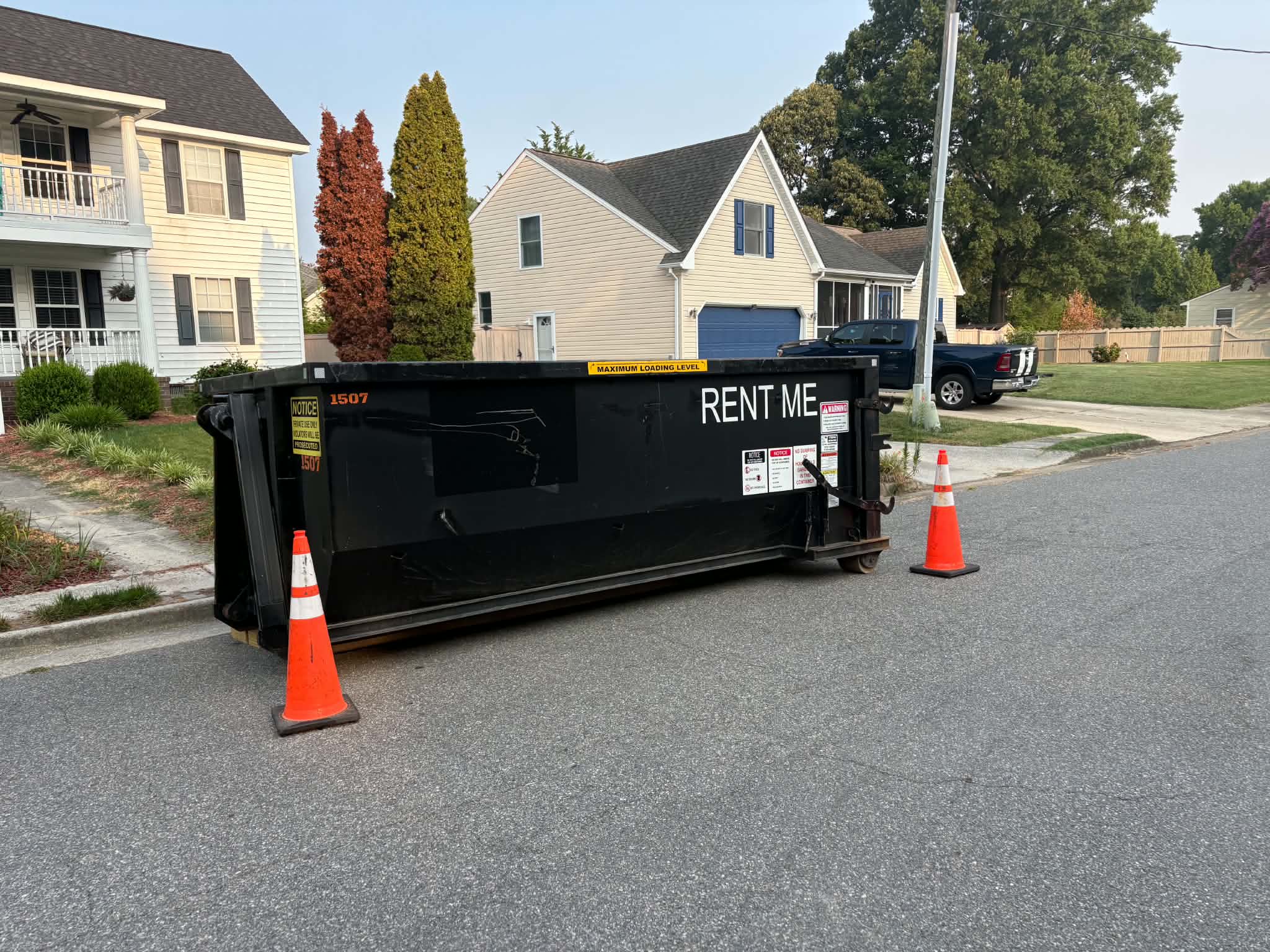 RISE Dumpsters 15-yard construction dumpster loaded with remodeling debris at a residential job site.